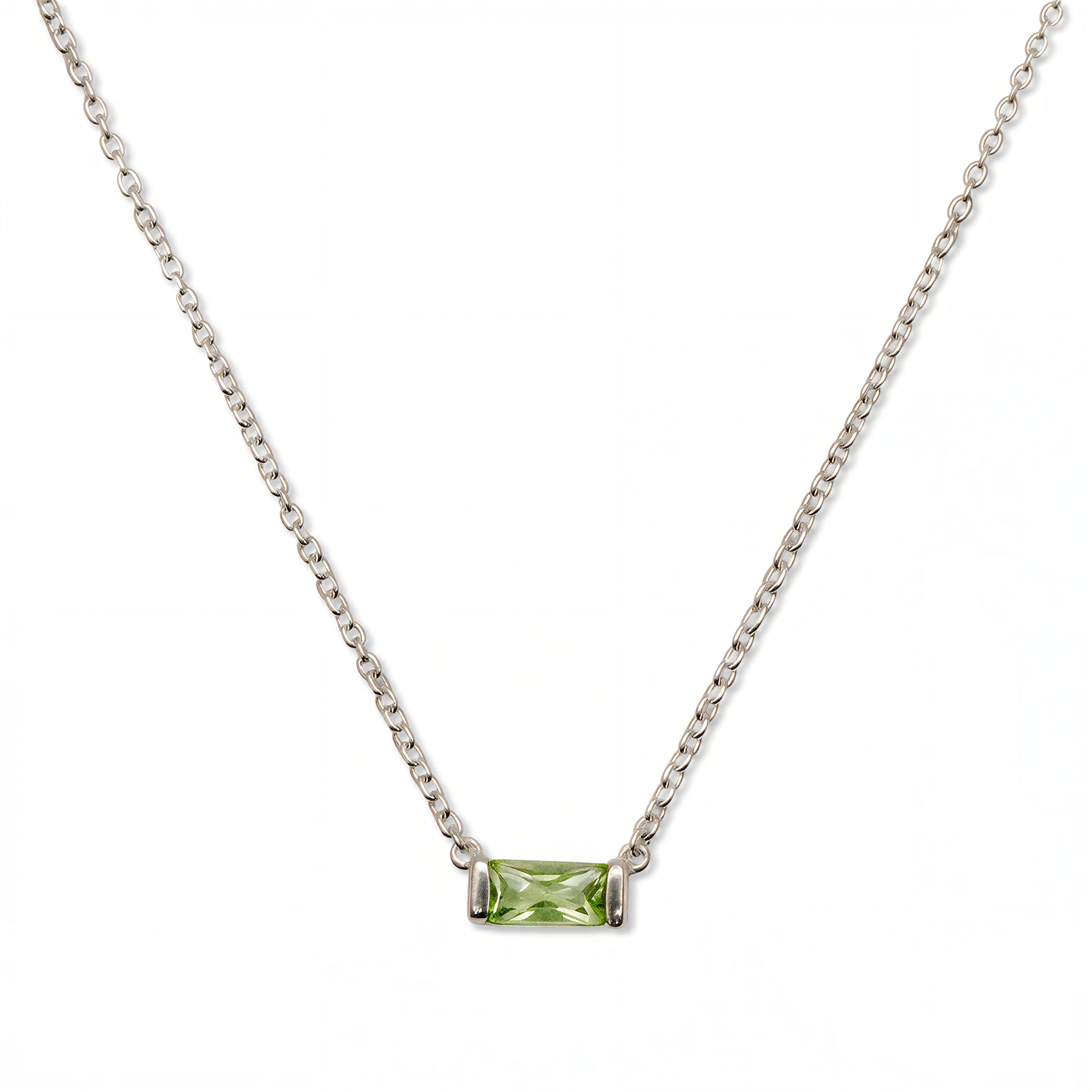 An August Birthstone Peridot Cubic Zirconia Baguette Necklace by Skōsh Jewelry, featuring a slim rectangular light green baguette stone set horizontally on a fine sterling silver chain, displayed against a white background.