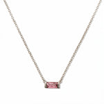An October Birthstone Pink Cubic Zirconia Baguette Necklace by Skōsh Jewelry, featuring a slim rectangular pink baguette stone set horizontally on a fine sterling silver chain, displayed against a white background.