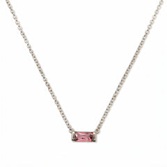 An October Birthstone Pink Cubic Zirconia Baguette Necklace by Skōsh Jewelry, featuring a slim rectangular pink baguette stone set horizontally on a fine sterling silver chain, displayed against a white background.