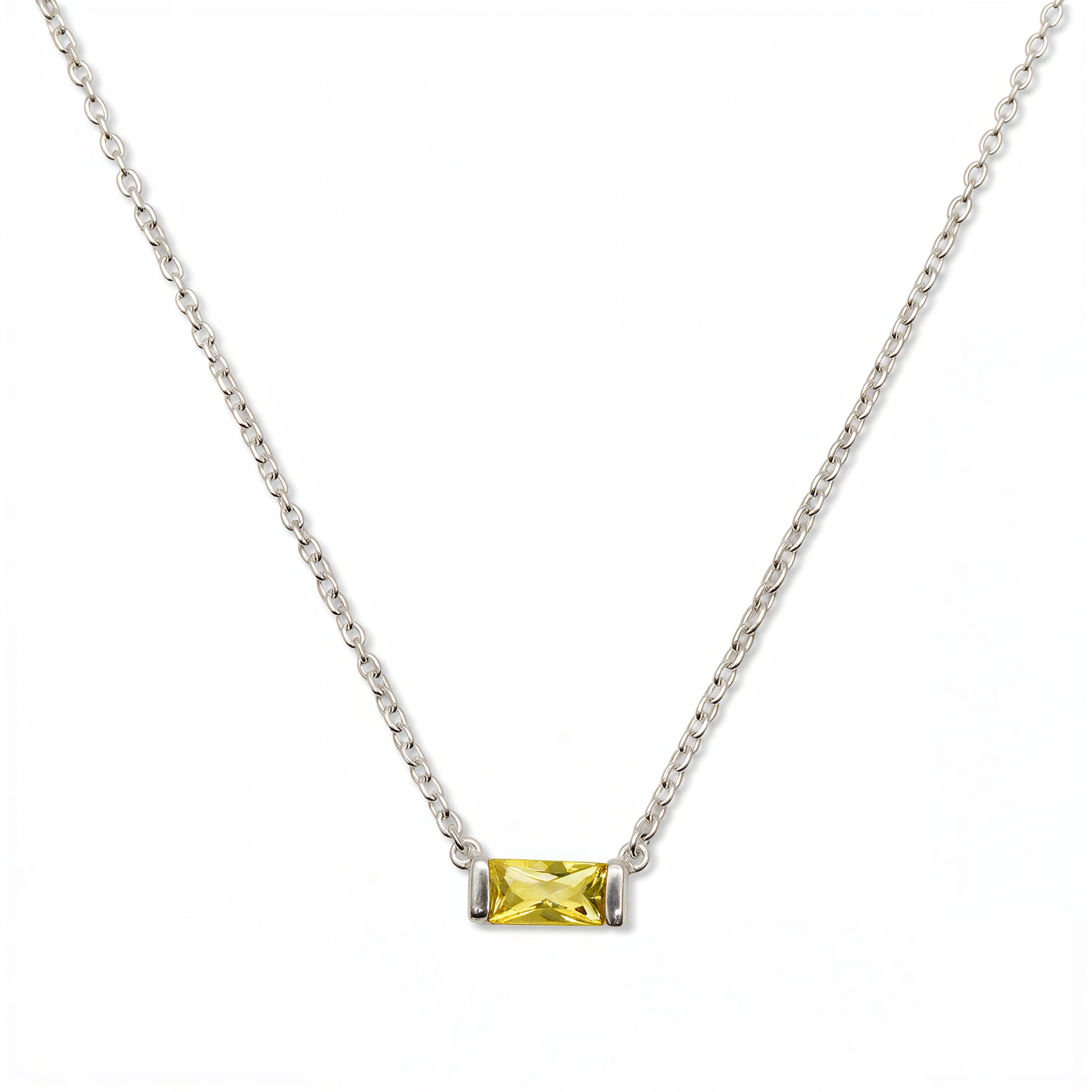 A November Birthstone Citrine Cubic Zirconia Baguette Necklace by Skōsh Jewelry, featuring a slim rectangular yellow baguette stone set horizontally on a fine sterling silver chain, displayed against a white background.