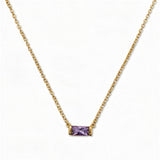 A June Birthstone Lavender Cubic Zirconia Baguette Necklace by Skōsh Jewelry, featuring a slim rectangular light purple baguette stone set horizontally on a fine gold chain, displayed against a white background.