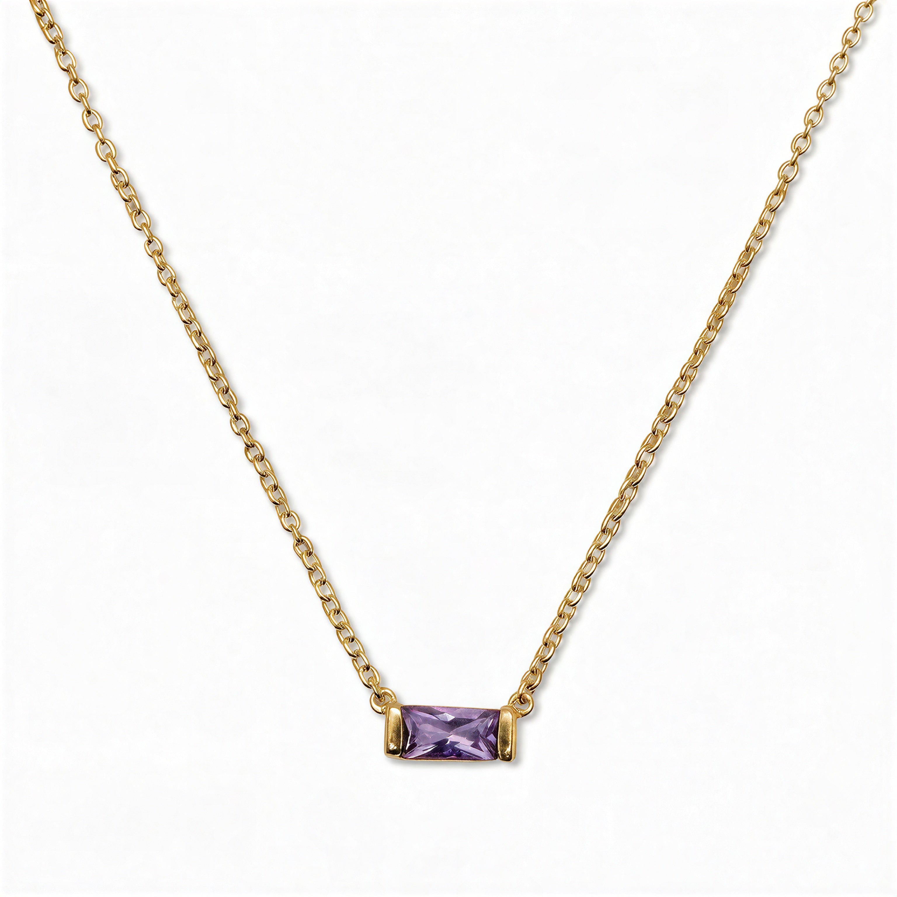 A June Birthstone Lavender Cubic Zirconia Baguette Necklace by Skōsh Jewelry, featuring a slim rectangular light purple baguette stone set horizontally on a fine gold chain, displayed against a white background.