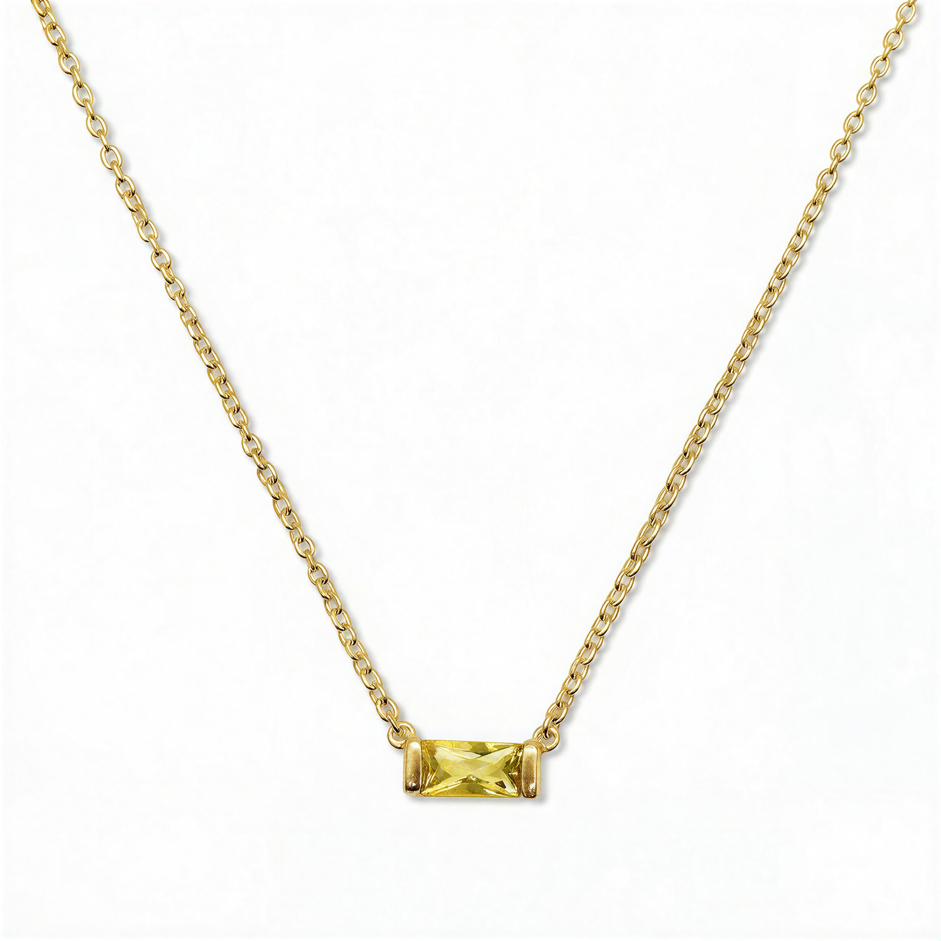 A November Birthstone Citrine Cubic Zirconia Baguette Necklace by Skōsh Jewelry, featuring a slim rectangular yellow baguette stone set horizontally on a fine gold chain, displayed against a white background.