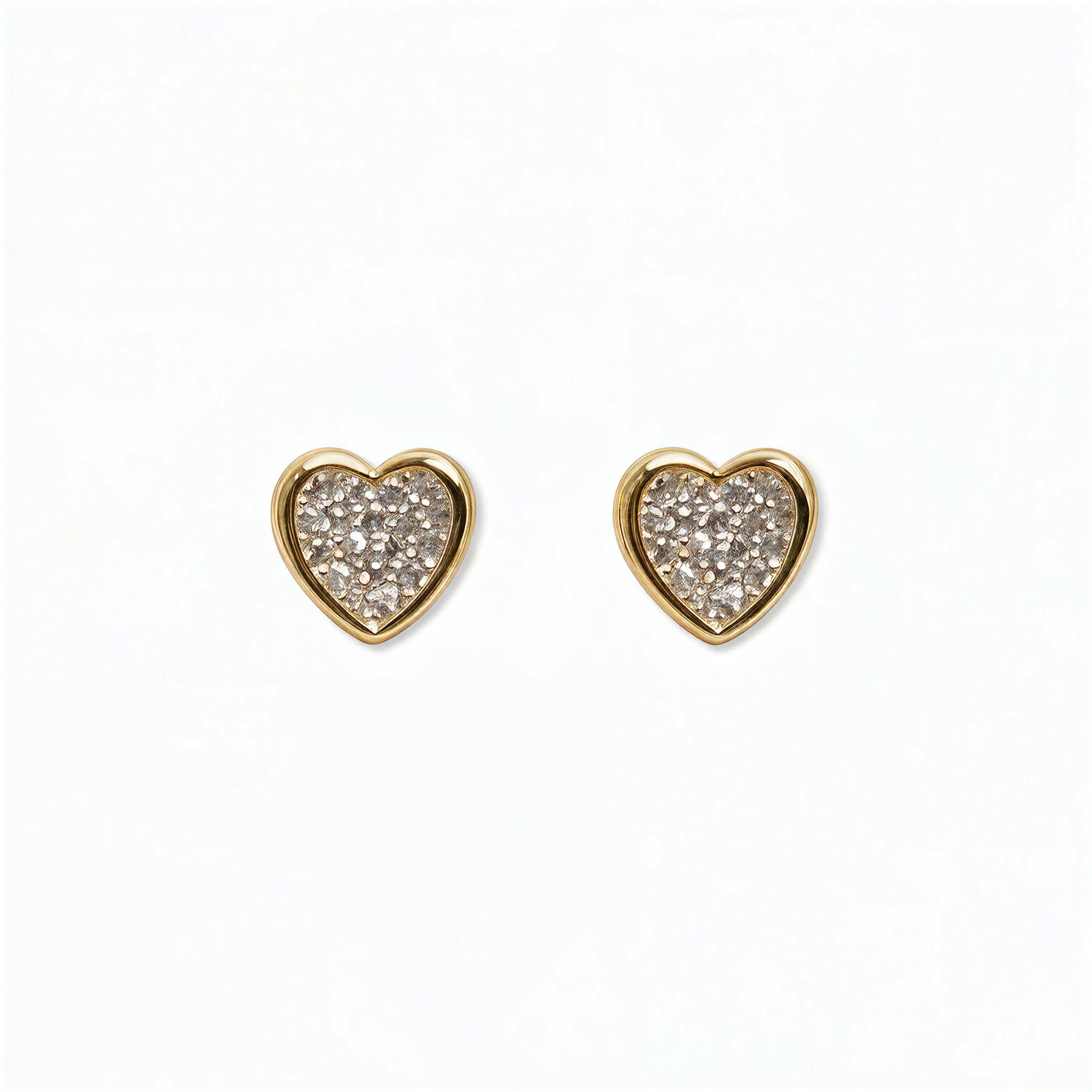 A pair of White Cubic Zirconia Pavé Heart Stud Earrings by Skōsh Jewelry, featuring heart-shaped studs covered in small clear pavé stones set in gold, displayed against a white background.