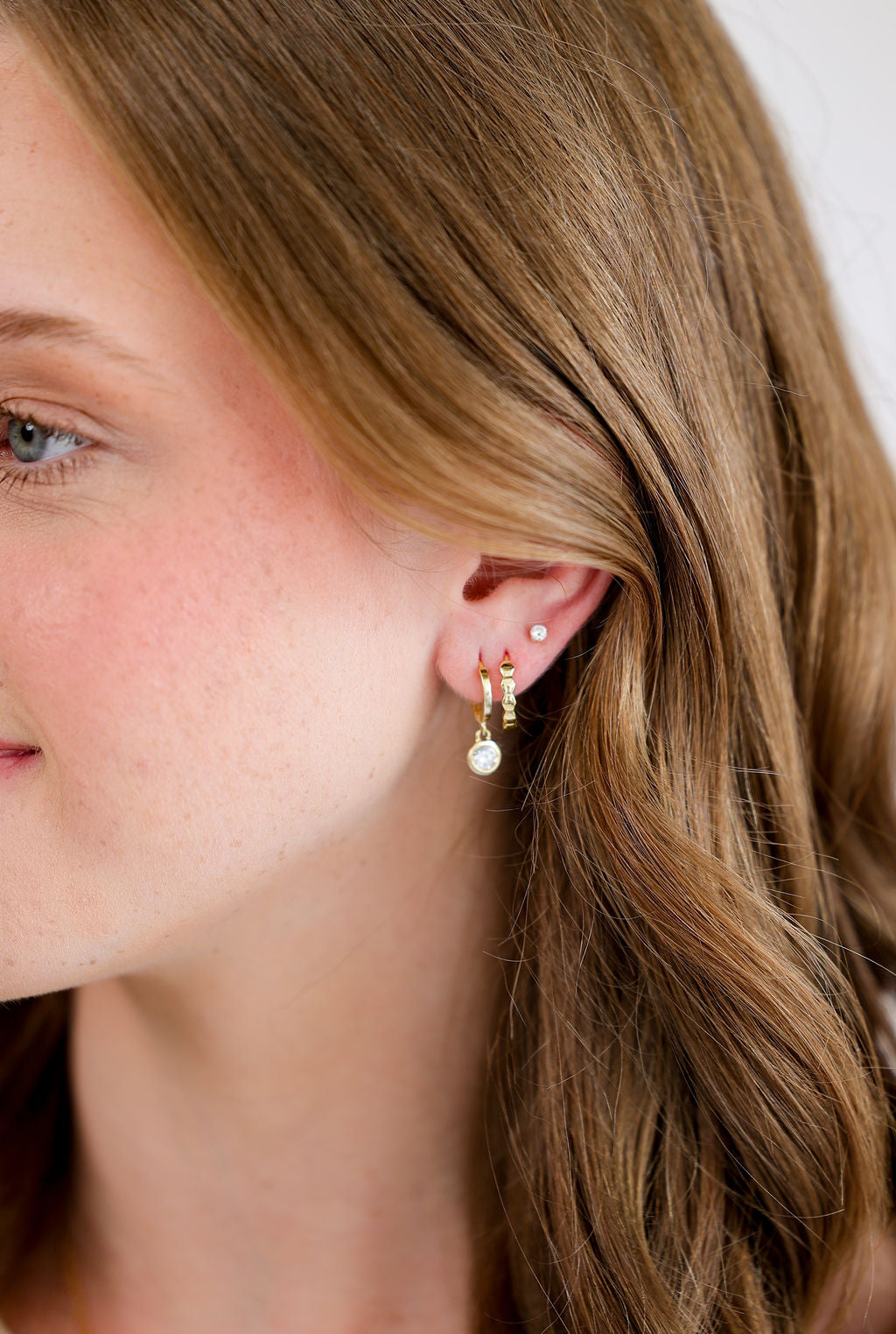 Bezel Set White Cubic Zirconia Drop Huggie Hoop Earrings in 14K gold over sterling silver by Skōsh Jewelry