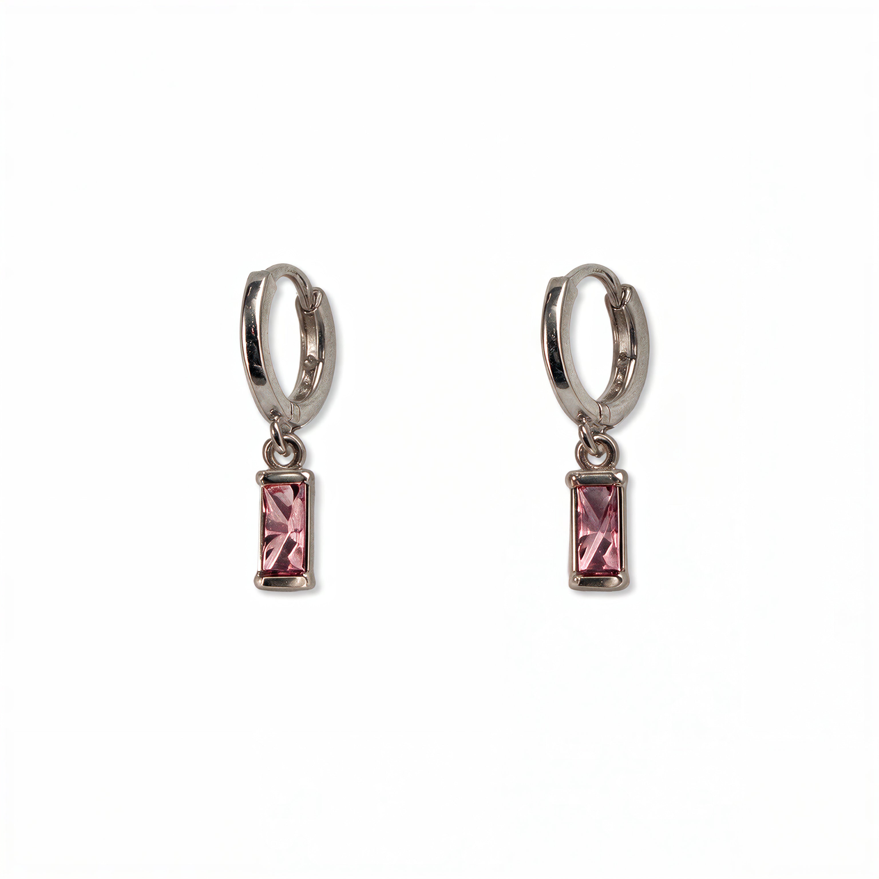 A pair of October Birthstone Pink Cubic Zirconia Baguette Earrings by Skōsh Jewelry, featuring small sterling silver huggie hoops, each with a rectangular pink baguette stone dangling below, displayed against a white background.