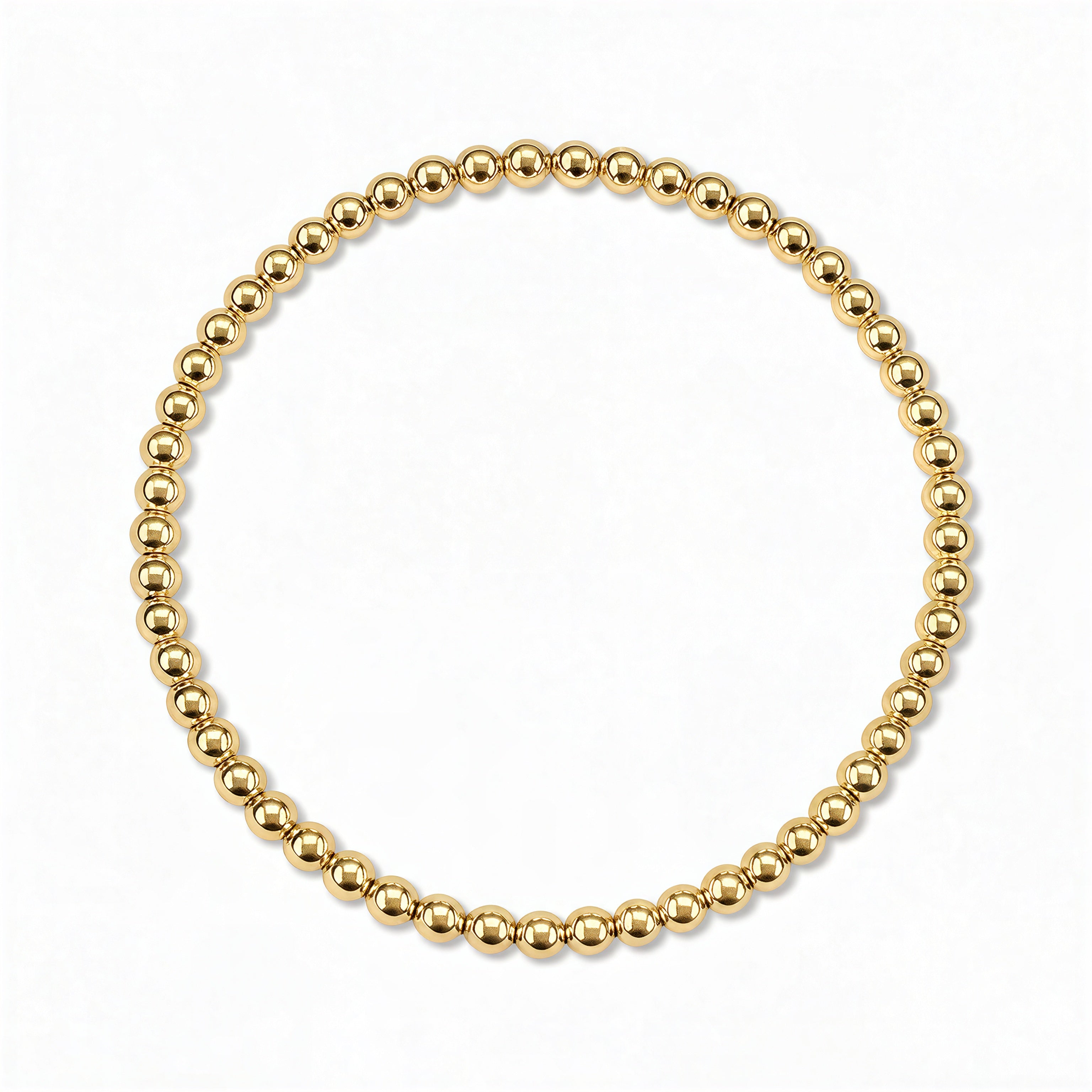 A Moonbeam 3mm Beaded Stretch Bracelet by Skōsh Jewelry, featuring a single strand of polished 3mm gold beads on a stretch cord, displayed against a white background.