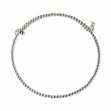 A Glint 2mm Beaded Coil Bracelet by Skōsh Jewelry, featuring a coil of small, polished 2mm sterling silver beads wrapped in a spiral, displayed against a white background.