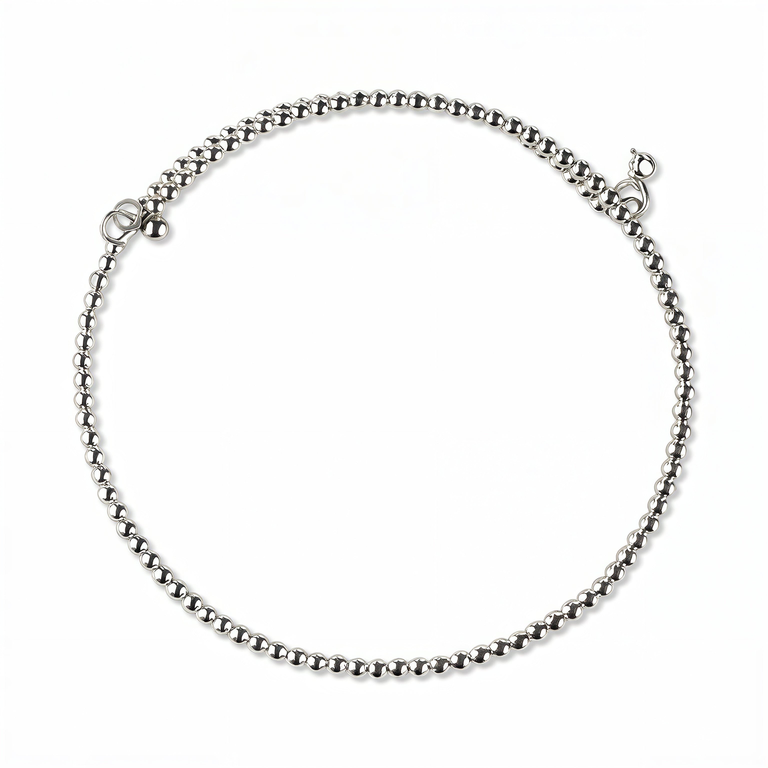 A Glint 2mm Beaded Coil Bracelet by Skōsh Jewelry, featuring a coil of small, polished 2mm sterling silver beads wrapped in a spiral, displayed against a white background.