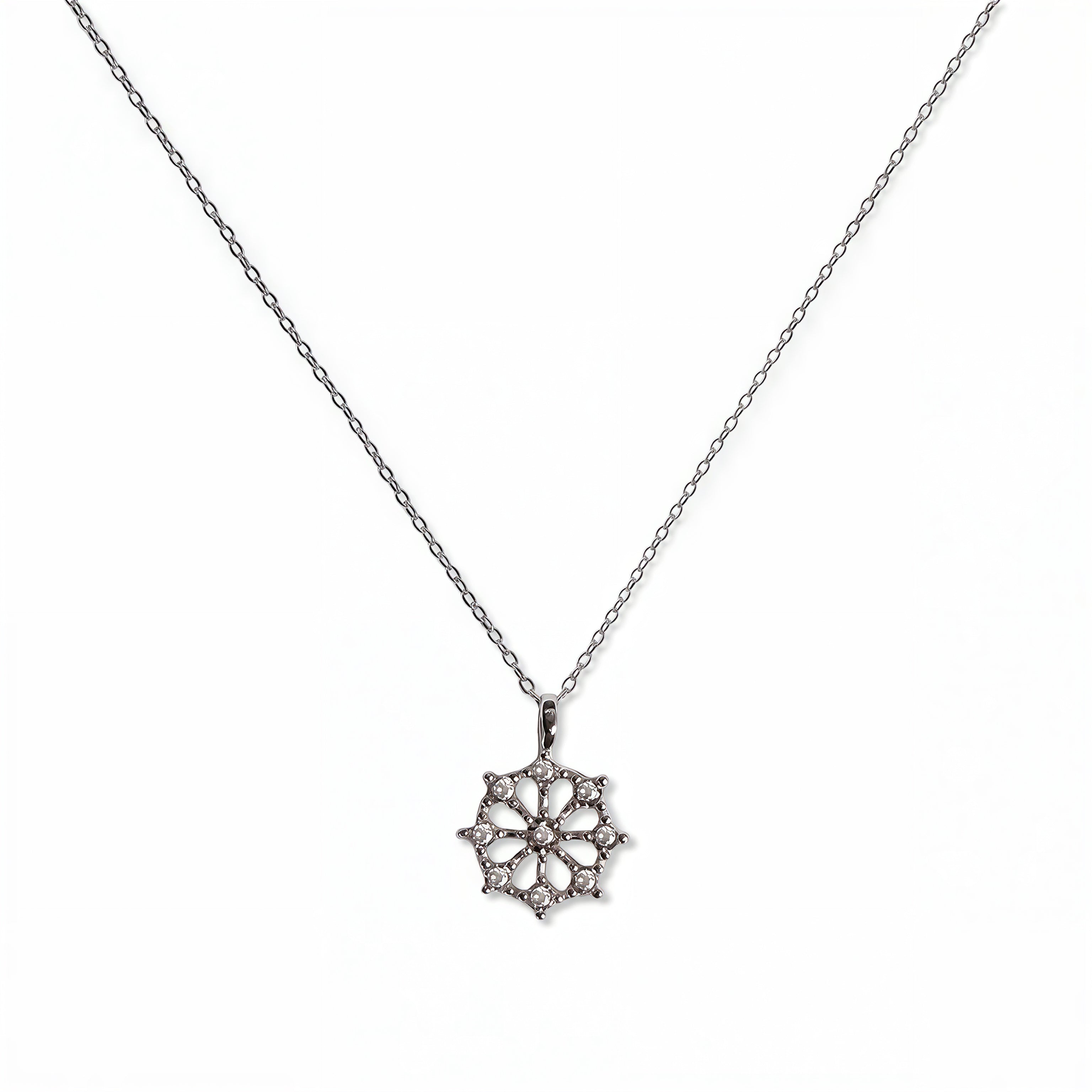 A Snowflake Pendant with White Cubic Zirconia Accent Necklace by Skōsh Jewelry, featuring a snowflake pendant accented with small clear stones on a fine sterling silver chain, displayed against a white background.