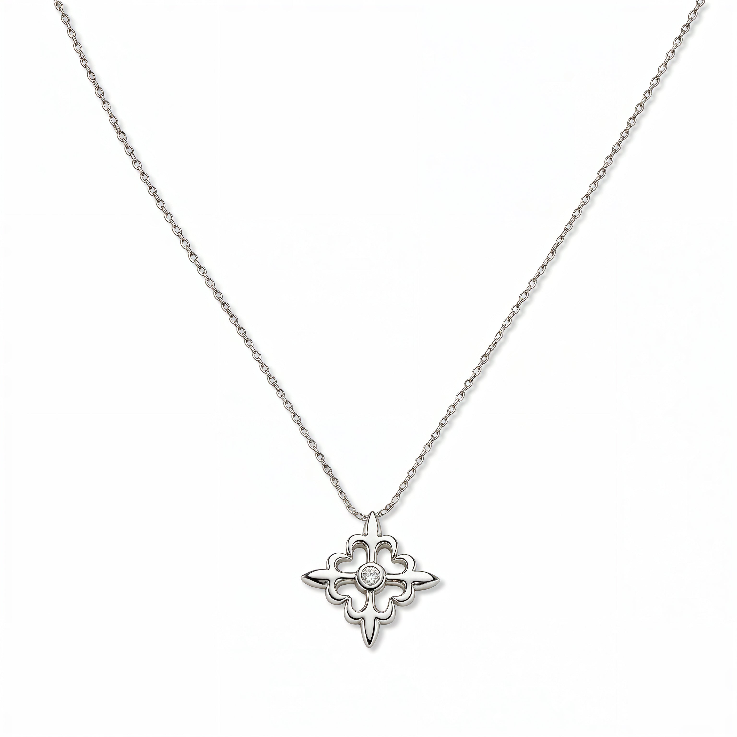A Louisiana Fleur-de-lis with White Cubic Zirconia Accent Pendant Necklace by Skōsh Jewelry, featuring a fleur-de-lis cross with a small clear stone at its center on a fine sterling silver chain, displayed against a white background.