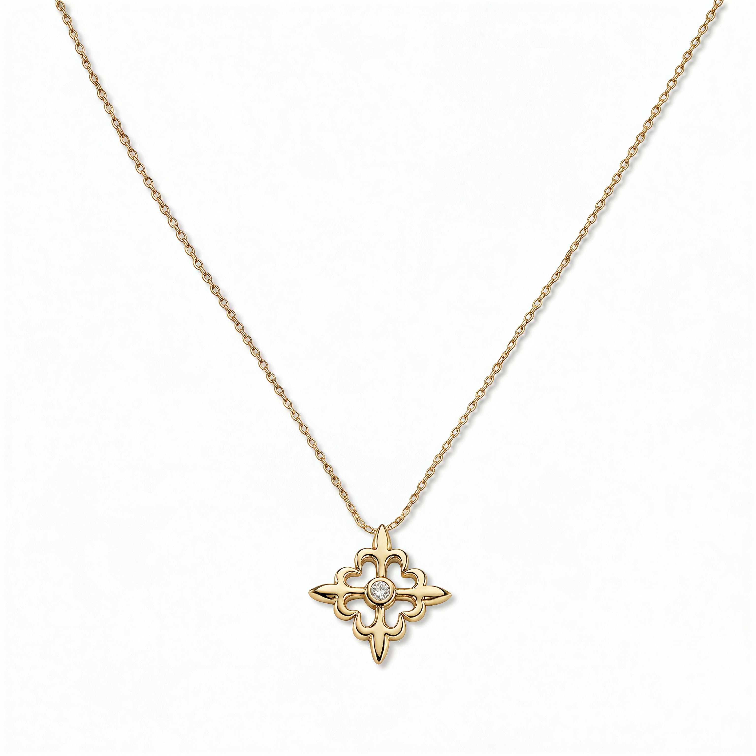 A Louisiana Fleur-de-lis with White Cubic Zirconia Accent Pendant Necklace by Skōsh Jewelry, featuring a fleur-de-lis cross with a small clear stone at its center on a fine gold chain, displayed against a white background.