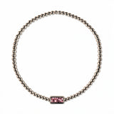 An October Birthstone Pink Cubic Zirconia Baguette Bracelet by Skōsh Jewelry, featuring a strand of polished sterling silver beads on a stretch cord with a rectangular pink baguette stone at the center, displayed against a white background.