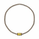 A November Birthstone Citrine Cubic Zirconia Baguette Bracelet by Skōsh Jewelry, featuring a strand of polished sterling silver beads on a stretch cord with a rectangular yellow baguette stone at the center, displayed against a white background.