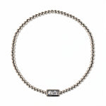 An April Birthstone White Cubic Zirconia Baguette Bracelet by Skōsh Jewelry, featuring a strand of polished sterling silver beads on a stretch cord with a rectangular clear baguette stone at the center, displayed against a white background.