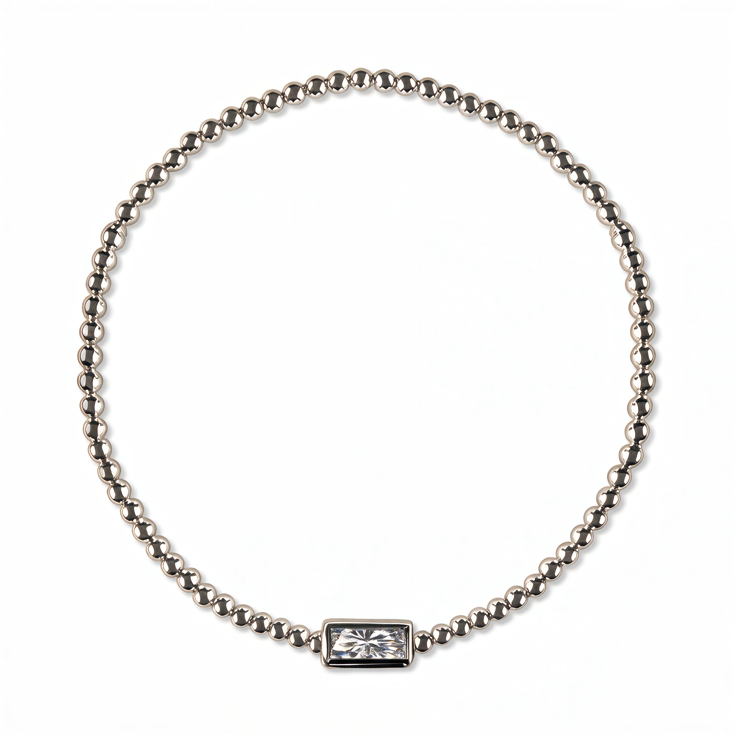 An April Birthstone White Cubic Zirconia Baguette Bracelet by Skōsh Jewelry, featuring a strand of polished sterling silver beads on a stretch cord with a rectangular clear baguette stone at the center, displayed against a white background.