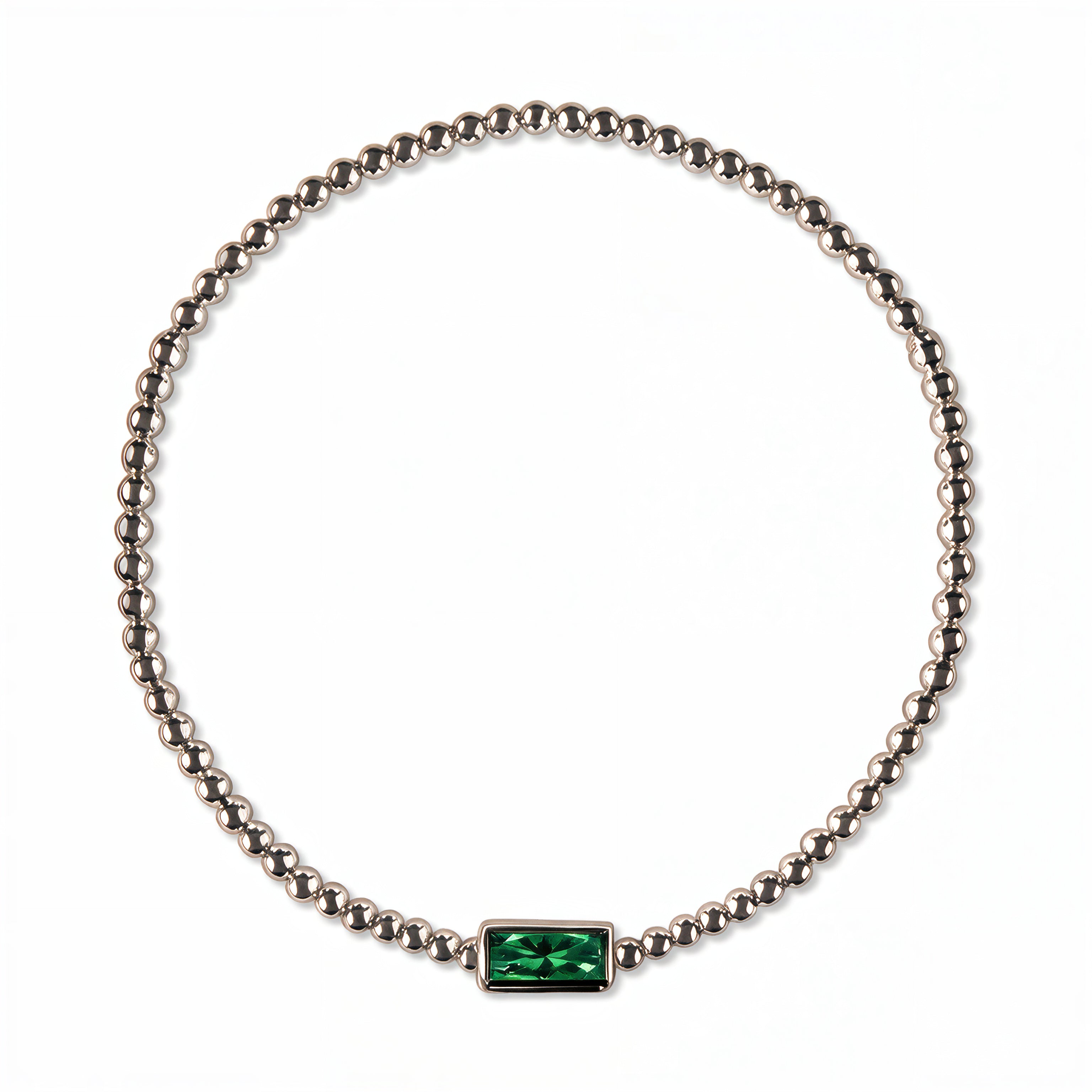 A May Birthstone Emerald Cubic Zirconia Baguette Bracelet by Skōsh Jewelry, featuring a strand of polished sterling silver beads on a stretch cord with a rectangular green baguette stone at the center, displayed against a white background.