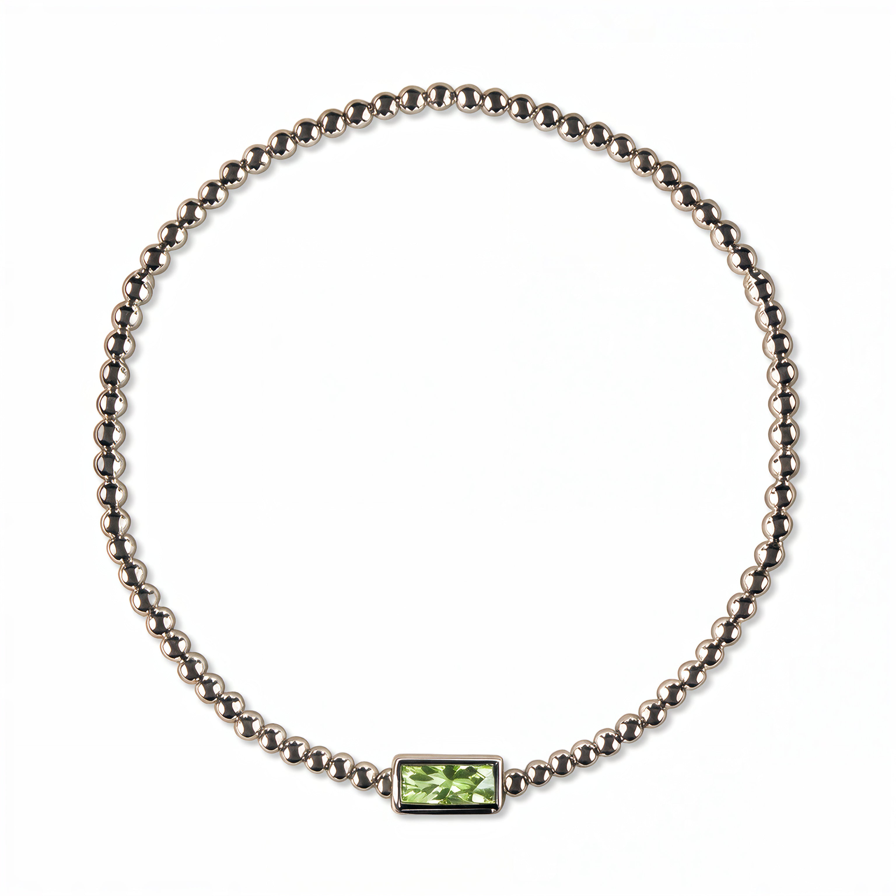 An August Birthstone Peridot Cubic Zirconia Baguette Bracelet by Skōsh Jewelry, featuring a strand of polished sterling silver beads on a stretch cord with a rectangular light green baguette stone at the center, displayed against a white background.