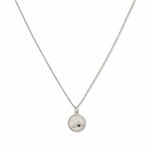 A Mustard Seed Pendant Necklace by Skōsh Jewelry, featuring a small round pendant with a mustard seed set beneath a mountain outline on a fine sterling silver chain, displayed against a white background.