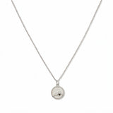 A Mustard Seed Pendant Necklace by Skōsh Jewelry, featuring a small round pendant with a mustard seed set beneath a mountain outline on a fine sterling silver chain, displayed against a white background.