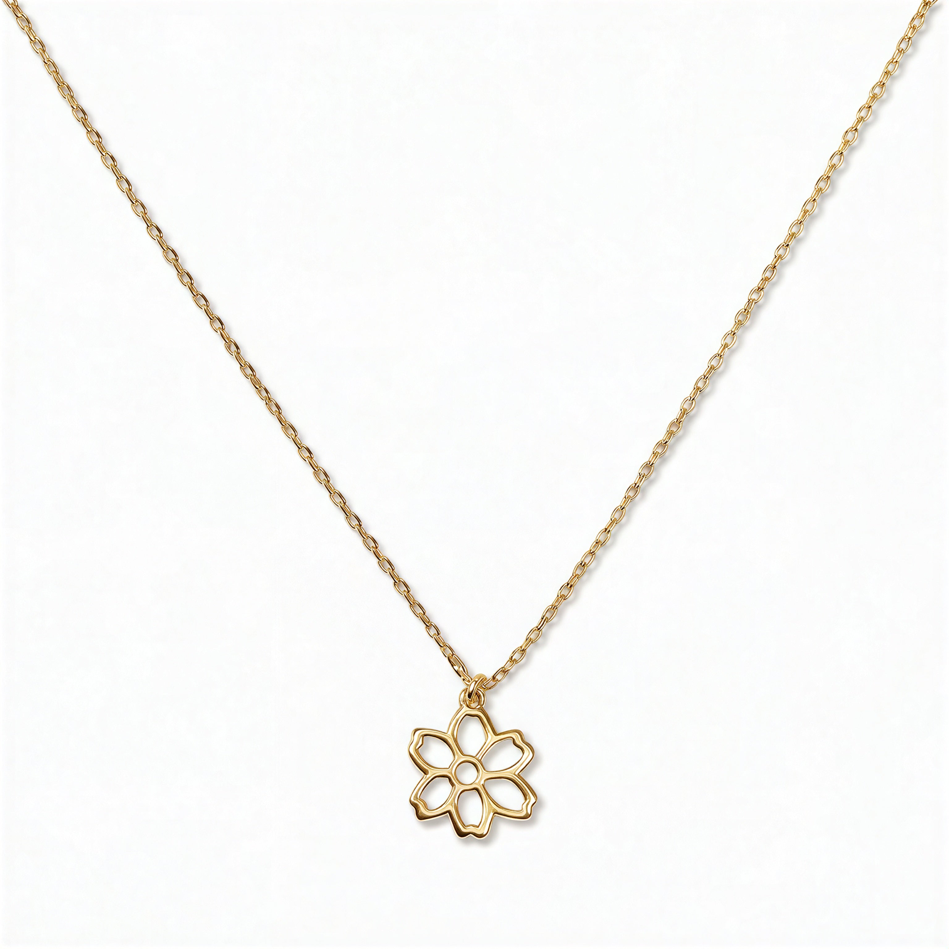 A Carnation January Flower Pendant Necklace by Skōsh Jewelry, featuring an open cutout carnation flower pendant on a fine gold chain, displayed against a white background.