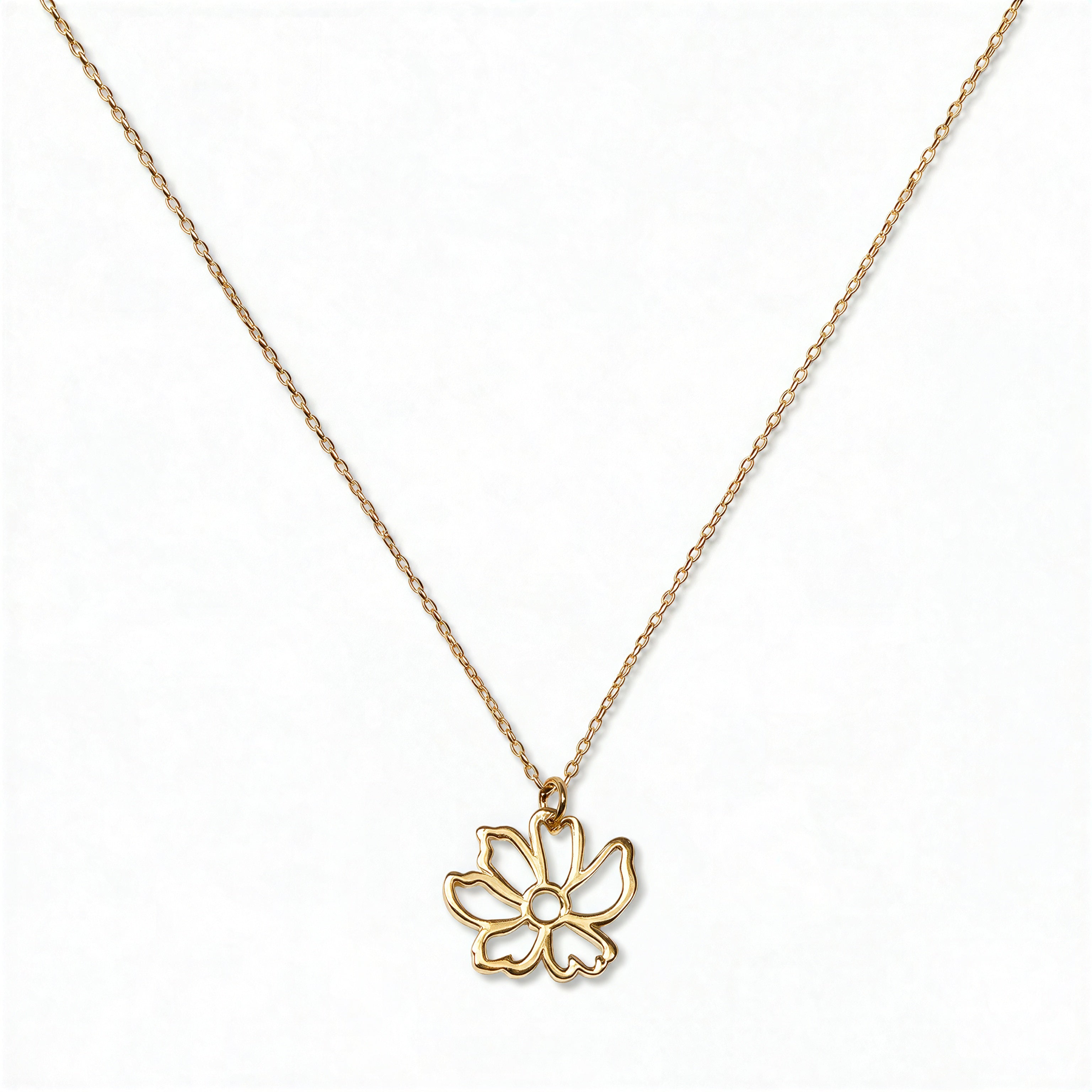 A Cosmos October Flower Pendant Necklace by Skōsh Jewelry, featuring an open cutout cosmos flower pendant on a fine gold chain, displayed against a white background.
