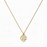 A Violet February Flower Pendant Necklace by Skōsh Jewelry, featuring an open cutout violet flower pendant on a fine gold chain, displayed against a white background.