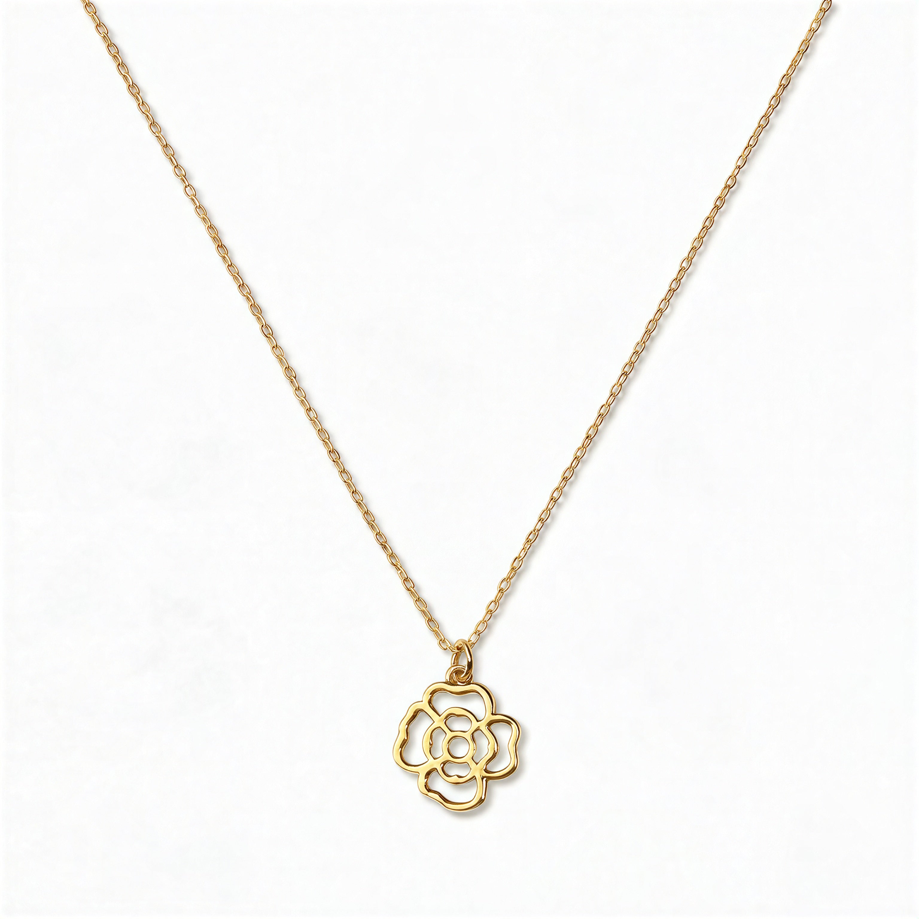 A Violet February Flower Pendant Necklace by Skōsh Jewelry, featuring an open cutout violet flower pendant on a fine gold chain, displayed against a white background.