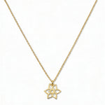 A Daffodil March Flower Pendant Necklace by Skōsh Jewelry, featuring an open cutout daffodil flower pendant on a fine gold chain, displayed against a white background.