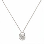 A Loved & Never Alone Bird Pendant Necklace by Skōsh Jewelry, featuring a rounded pendant with a cutout of a small bird on a fine sterling silver chain, displayed against a white background.