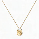 A Loved & Never Alone Bird Pendant Necklace by Skōsh Jewelry, featuring a rounded pendant with a cutout of a small bird on a fine gold chain, displayed against a white background.