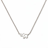 A Never Forget Elephant Necklace by Skōsh Jewelry, featuring an open outline of a small elephant set sideways on a fine sterling silver chain, displayed against a white background.
