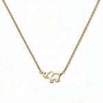 A Never Forget Elephant Necklace by Skōsh Jewelry, featuring an open outline of a small elephant set sideways on a fine gold chain, displayed against a white background.