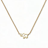 A Never Forget Elephant Necklace by Skōsh Jewelry, featuring an open outline of a small elephant set sideways on a fine gold chain, displayed against a white background.