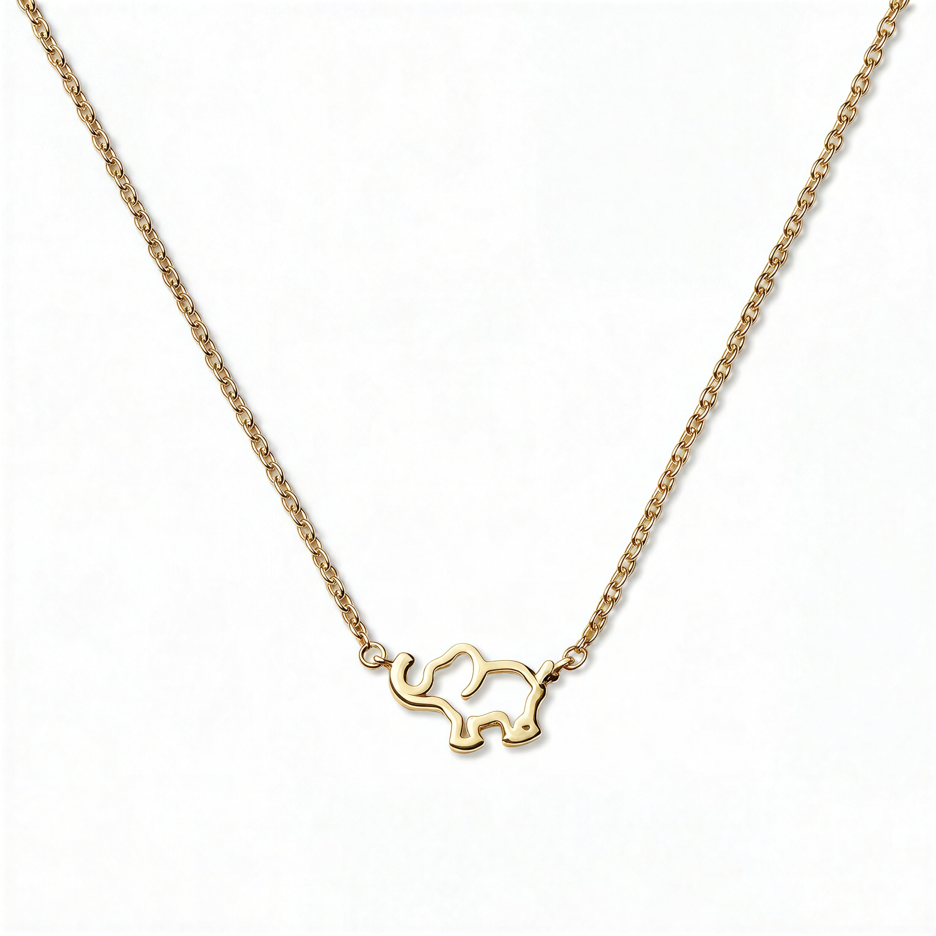 A Never Forget Elephant Necklace by Skōsh Jewelry, featuring an open outline of a small elephant set sideways on a fine gold chain, displayed against a white background.