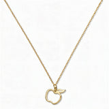 A Cut Out Apple Pendant Necklace by Skōsh Jewelry, featuring an open cutout outline of an apple on a fine gold chain, displayed against a white background.