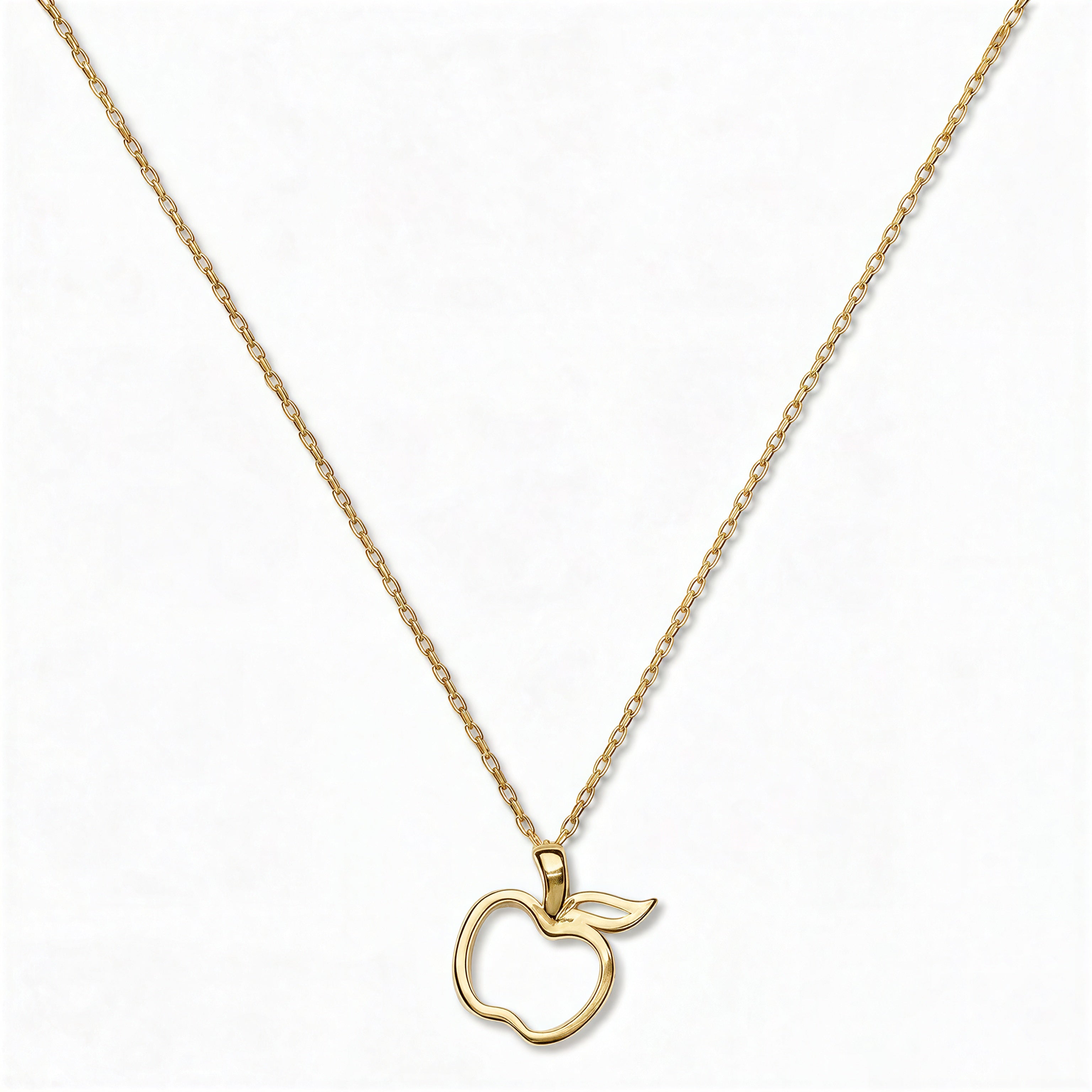 A Cut Out Apple Pendant Necklace by Skōsh Jewelry, featuring an open cutout outline of an apple on a fine gold chain, displayed against a white background.