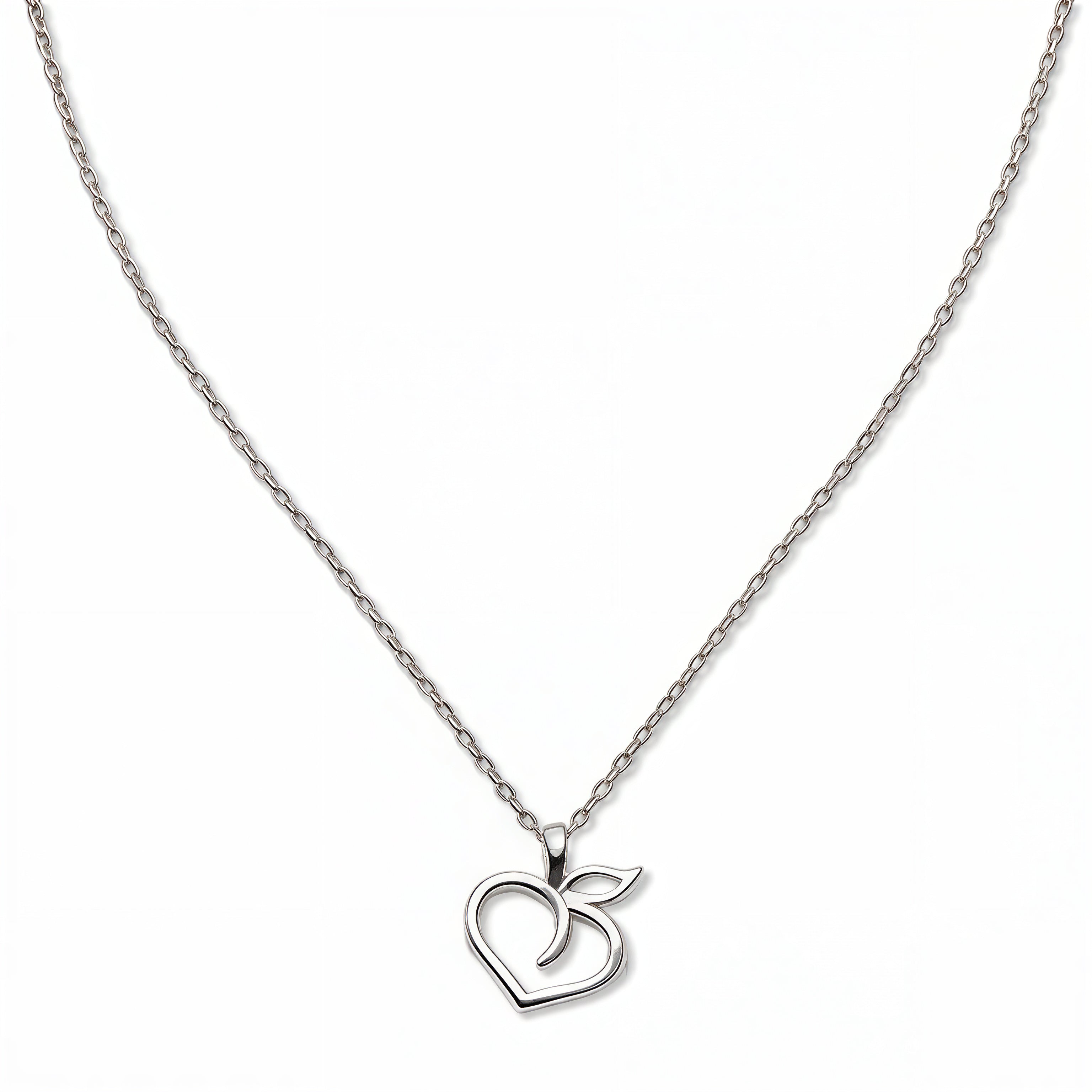 A Peach Pendant Necklace by Skōsh Jewelry, featuring an open outline of a peach with a leaf on a fine sterling silver chain, displayed against a white background.