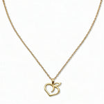A Peach Pendant Necklace by Skōsh Jewelry, featuring an open outline of a peach with a leaf on a fine gold chain, displayed against a white background.