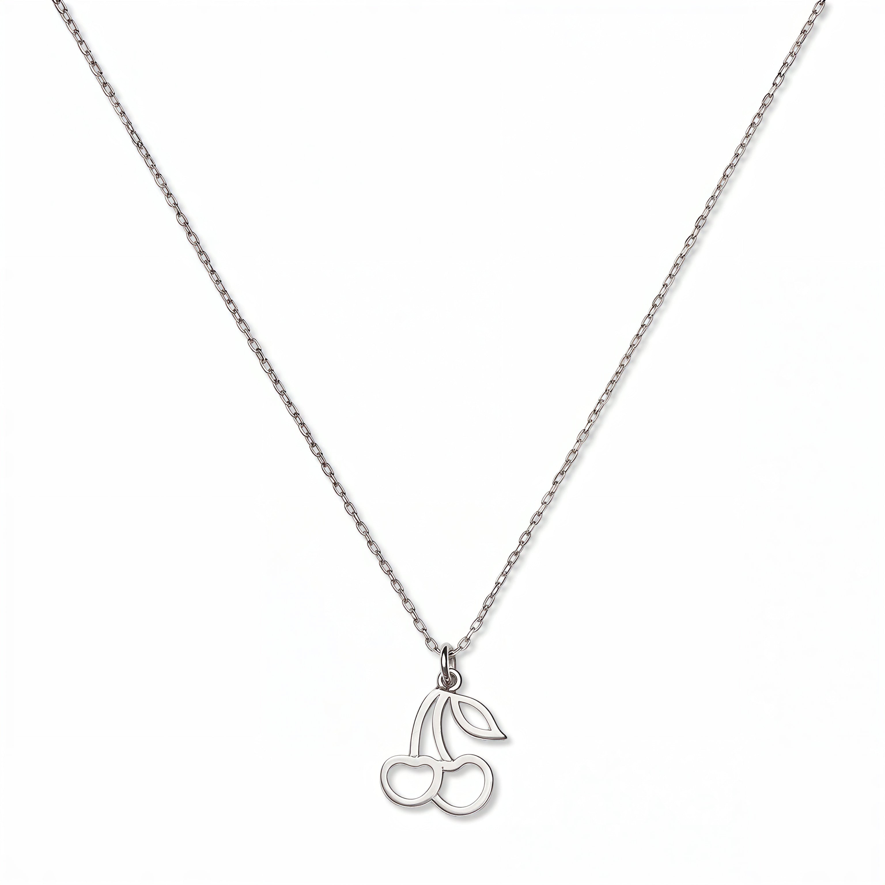 A Double Cherry Pendant Necklace by Skōsh Jewelry, featuring two small cherries joined at the stem on a fine sterling silver chain, displayed against a white background.