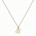 A Double Cherry Pendant Necklace by Skōsh Jewelry, featuring two small cherries joined at the stem on a fine gold chain, displayed against a white background.