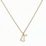 A Pear Pendant Necklace by Skōsh Jewelry, featuring an open outline of a pear on a fine gold chain, displayed against a white background.
