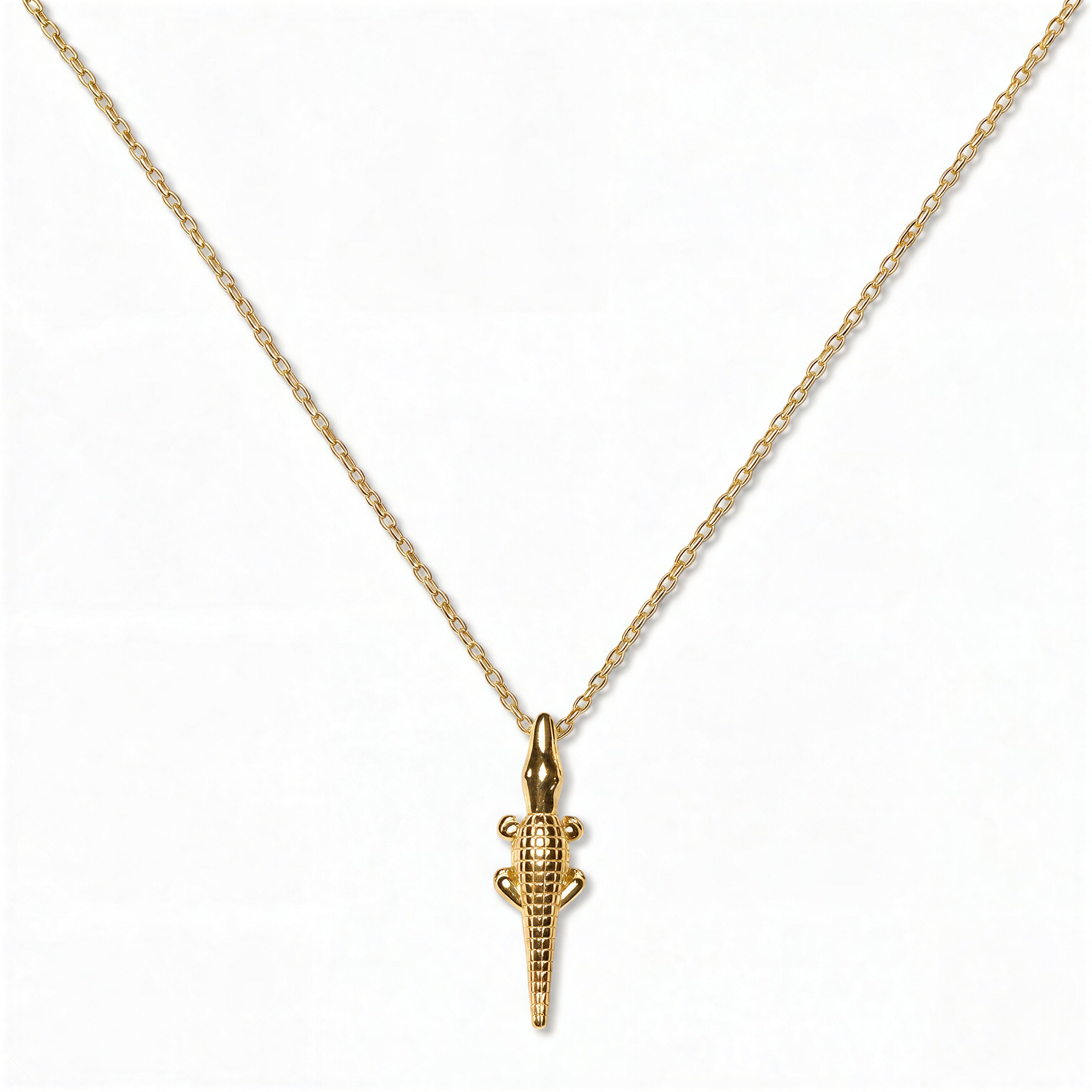 A See You Later Alligator Pendant Necklace by Skōsh Jewelry, featuring a slim alligator pendant hanging vertically on a fine gold chain, displayed against a white background.