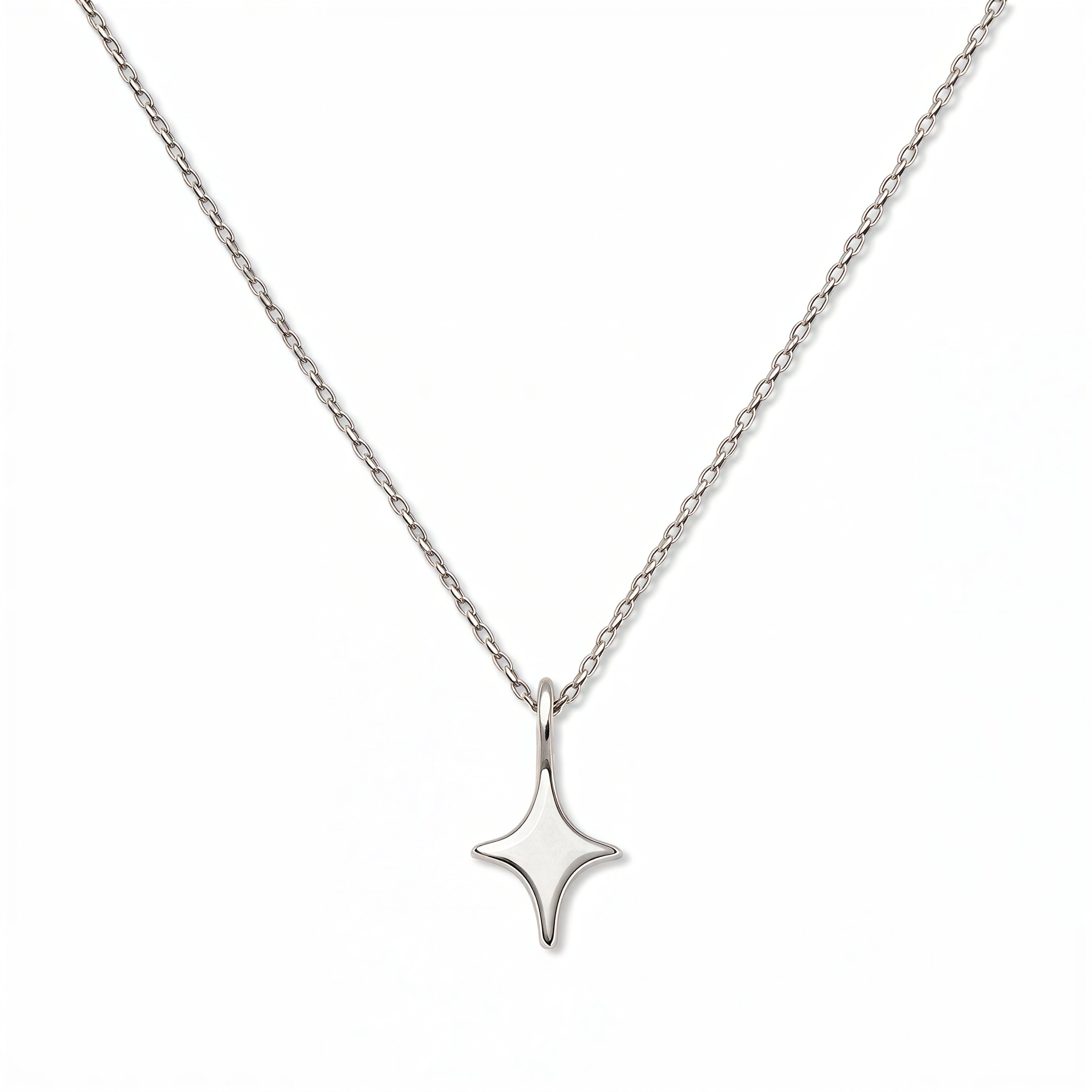 A Starlight Pendant Necklace by Skōsh Jewelry, featuring a sleek four-point star pendant on a fine sterling silver chain, displayed against a white background.