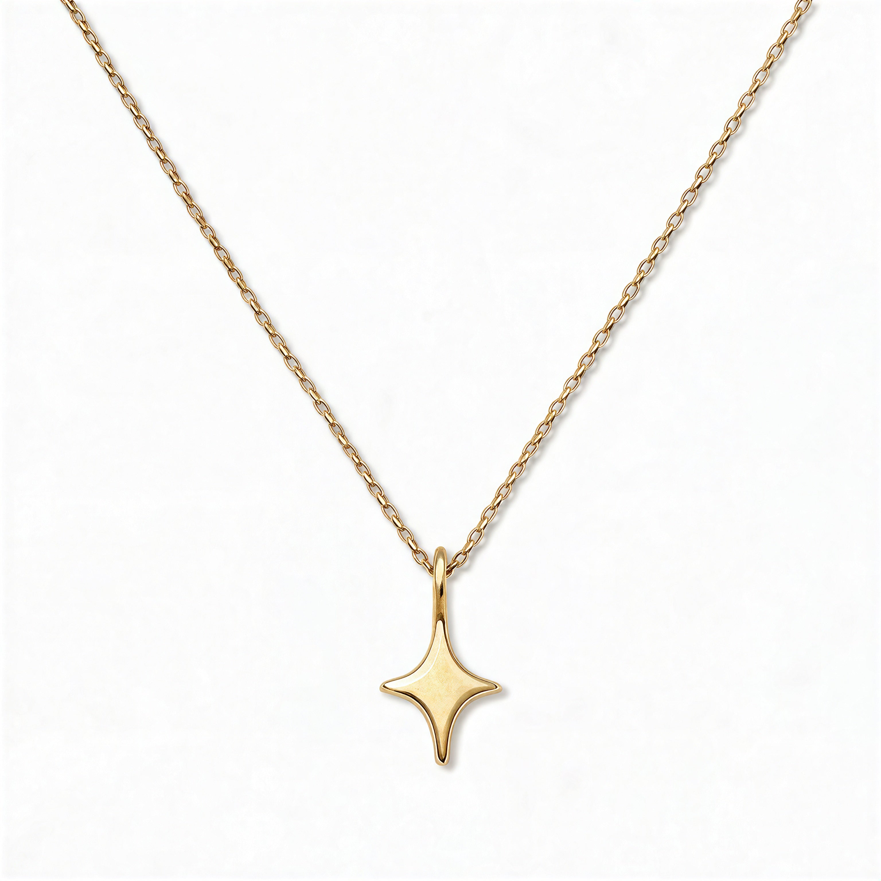 A Starlight Pendant Necklace by Skōsh Jewelry, featuring a sleek four-point star pendant on a fine gold chain, displayed against a white background.