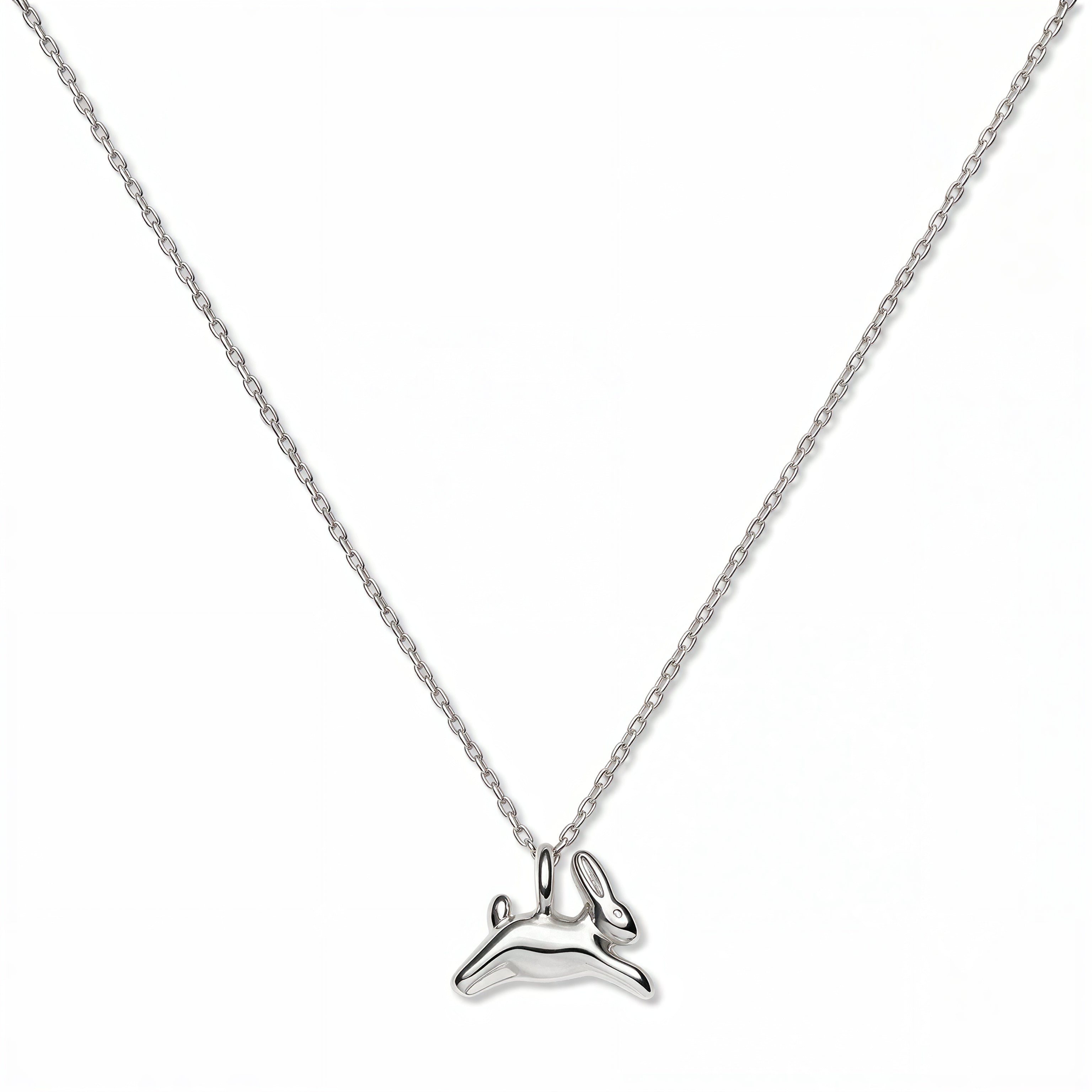 A New Beginnings Rabbit Pendant Necklace by Skōsh Jewelry, featuring a small leaping rabbit pendant on a fine sterling silver chain, displayed against a white background.
