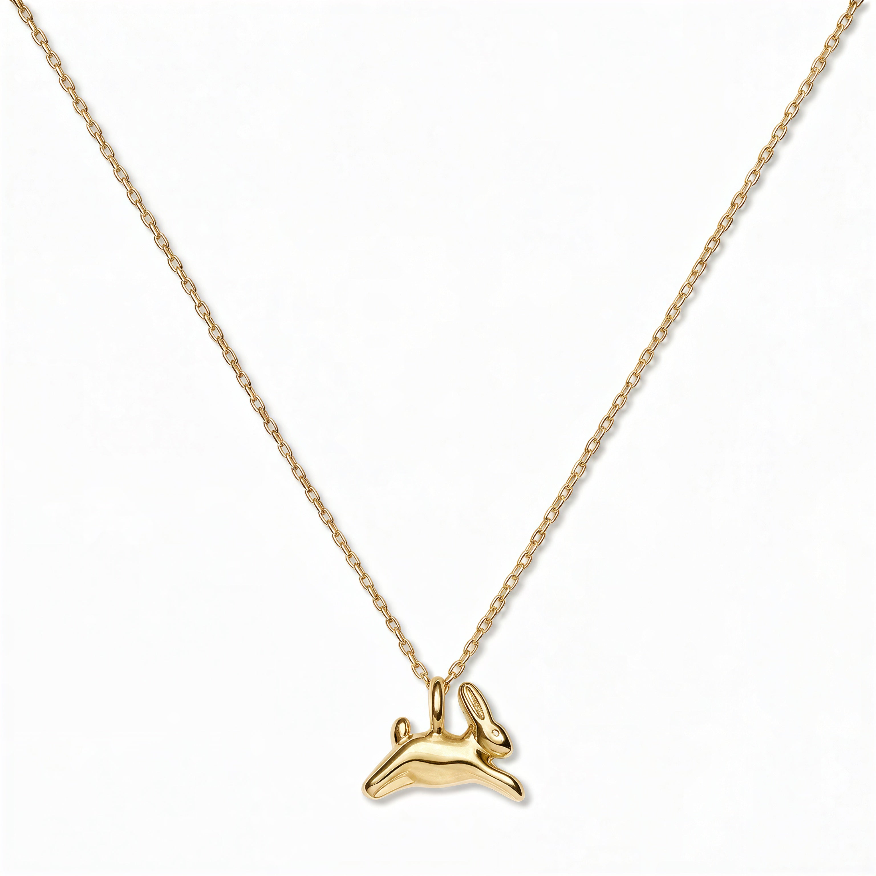 A New Beginnings Rabbit Pendant Necklace by Skōsh Jewelry, featuring a small leaping rabbit pendant on a fine gold chain, displayed against a white background.