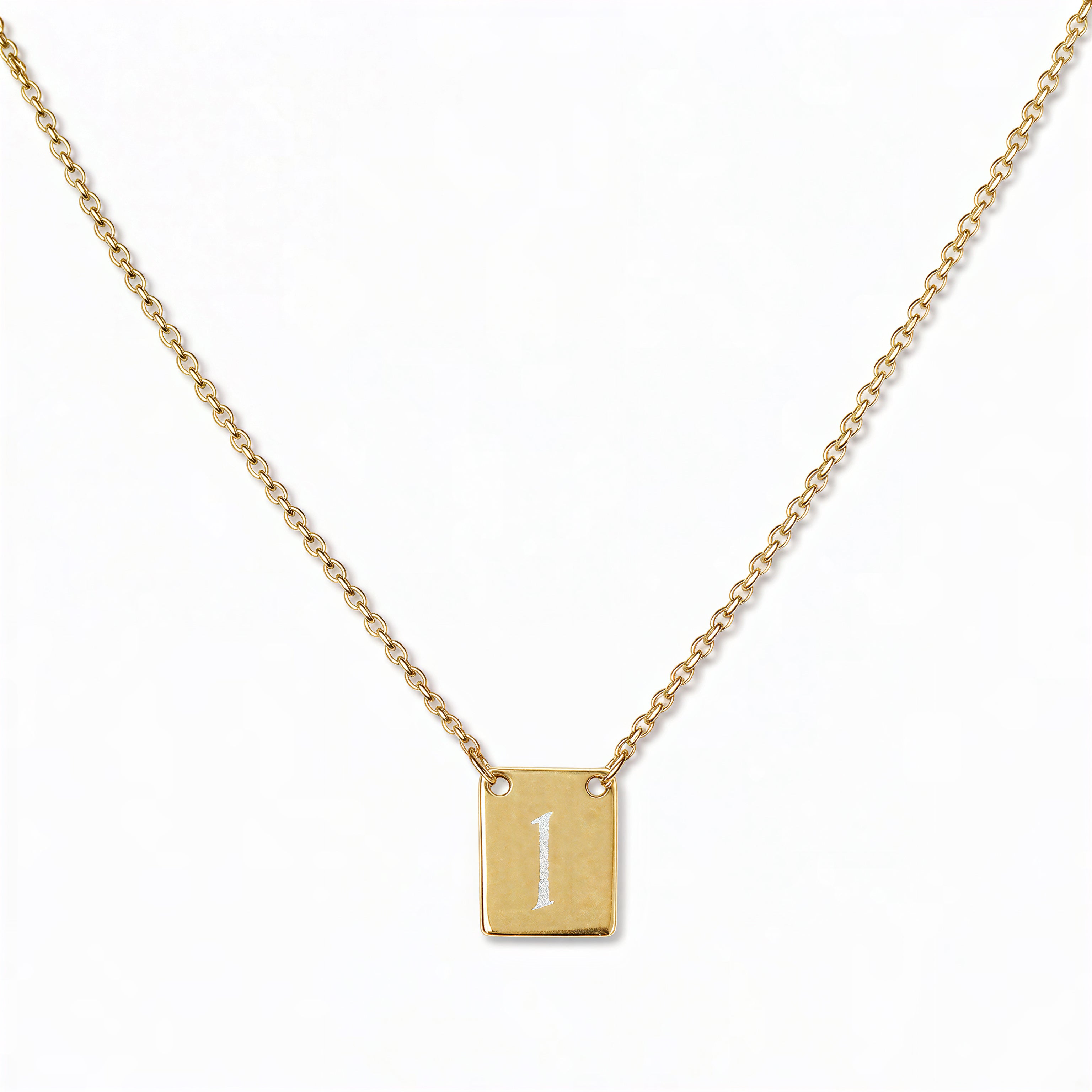 An Engraved Initial Necklace Letter I by Skōsh Jewelry, featuring a small rectangular tag engraved with the letter I on a fine gold chain, displayed against a white background.