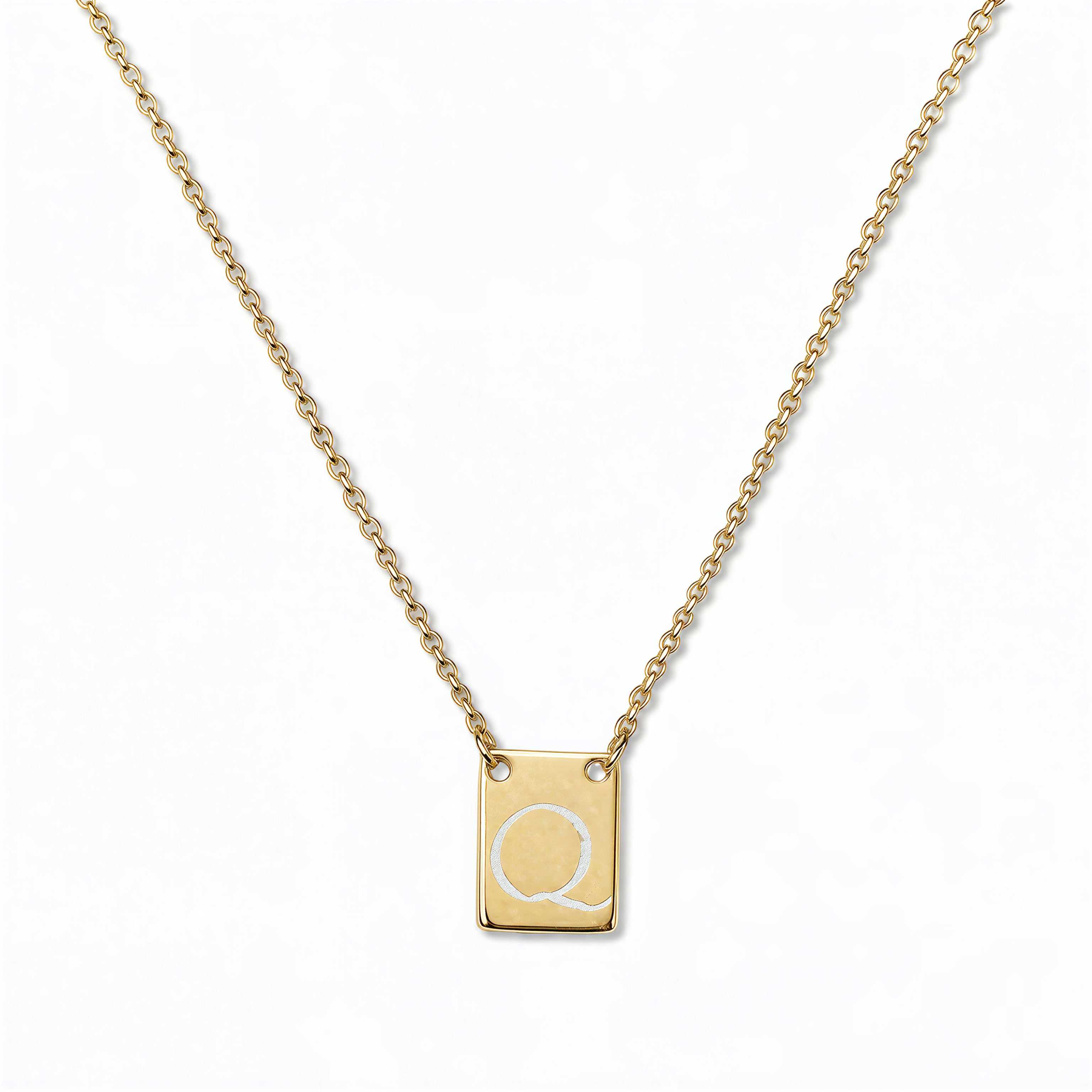 An Engraved Initial Necklace Letter Q by Skōsh Jewelry, featuring a small rectangular tag engraved with the letter Q on a fine gold chain, displayed against a white background.