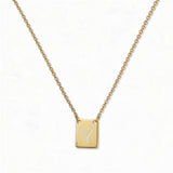 An Engraved Initial Necklace Letter Y by Skōsh Jewelry, featuring a small rectangular tag engraved with the letter Y on a fine gold chain, displayed against a white background.